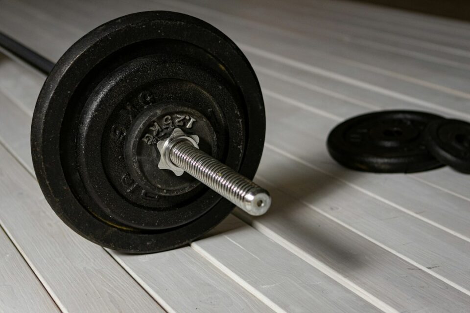 strength training for beginners cover illustration with barbell and 12‑week calendar grid