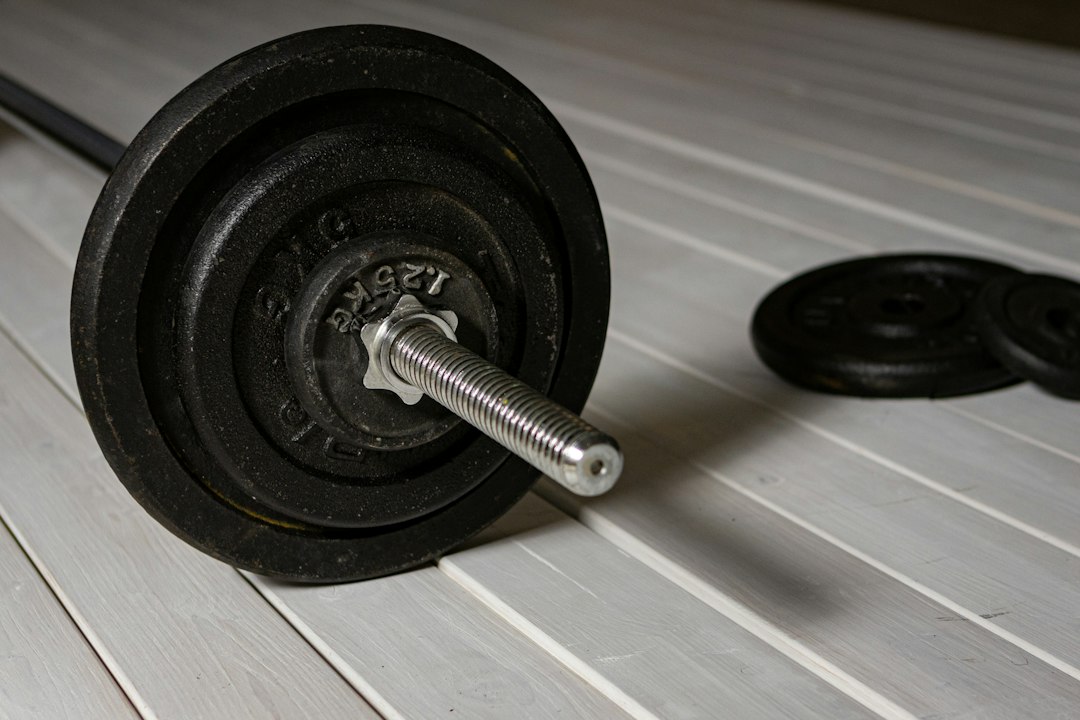strength training for beginners cover illustration showing a barbell, a simple calendar grid, and checkmarks for steady weekly progress